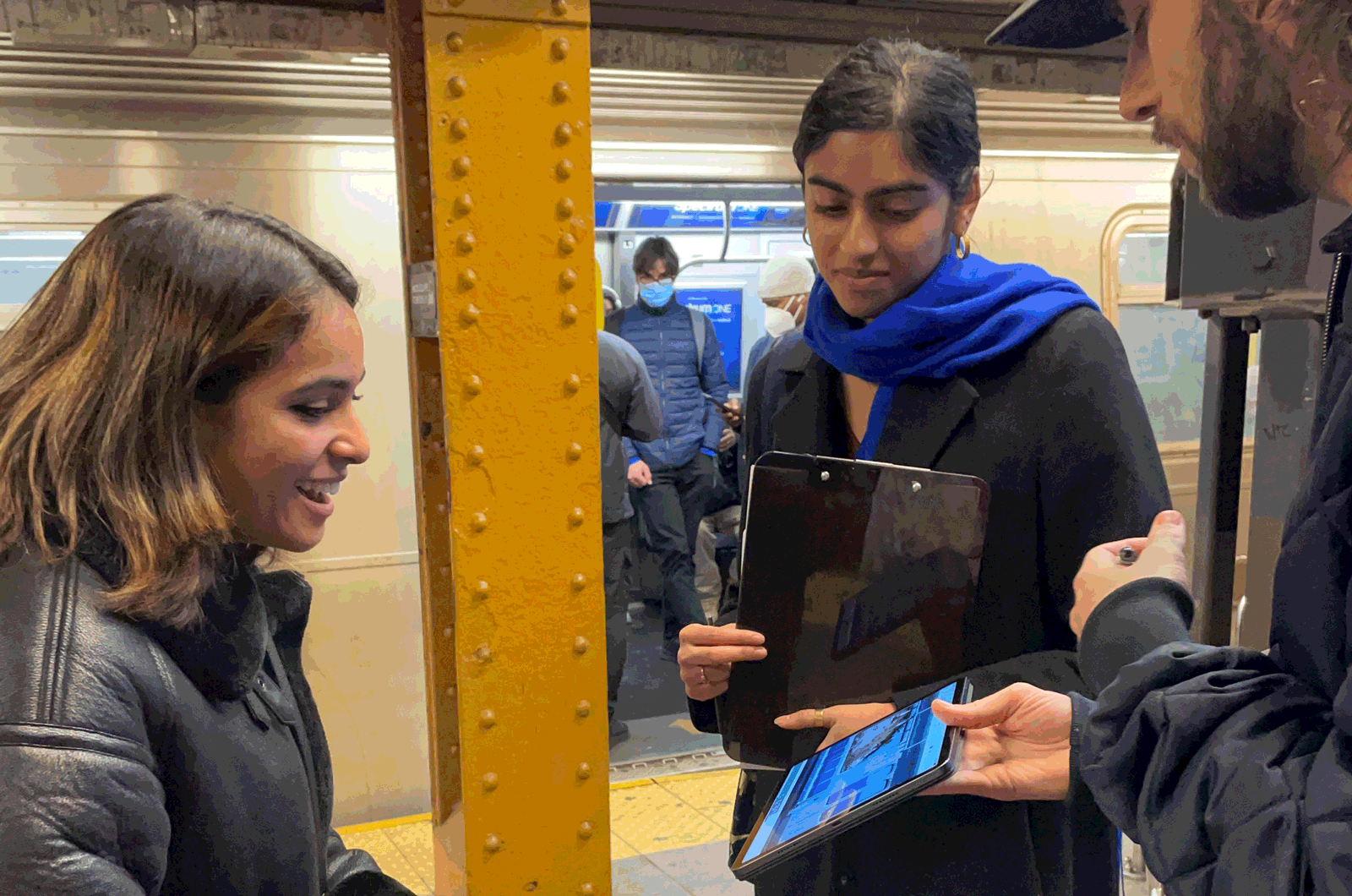 interviewing a subway rider outside train